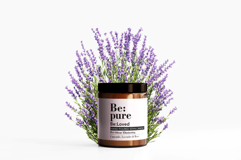 Be:pure candle in packaging with a background of lavender