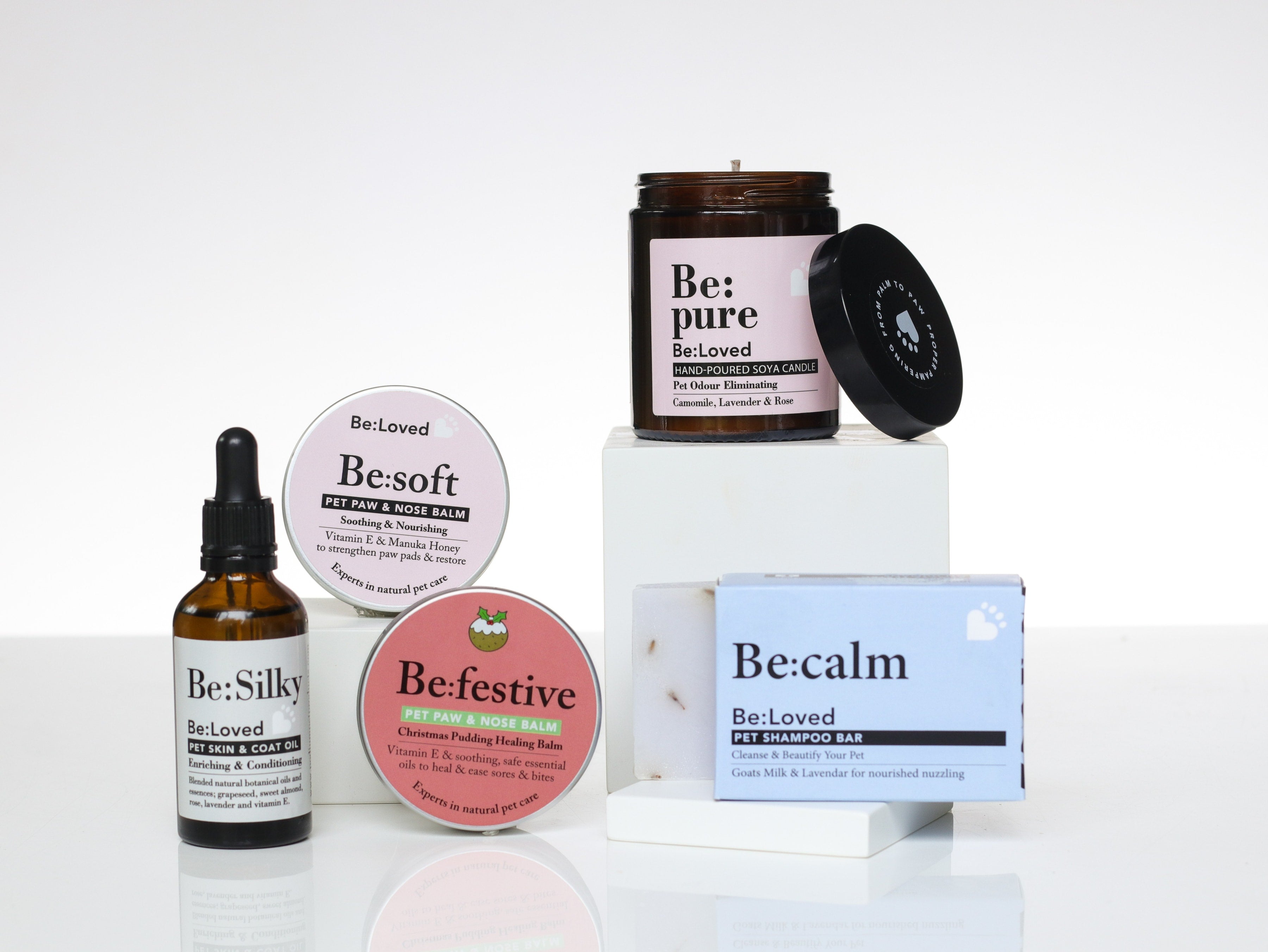 Be:Silky, Be:Soft, Be:Festive, Be:Pure and Be:Calm products placed on white blocks with a white background