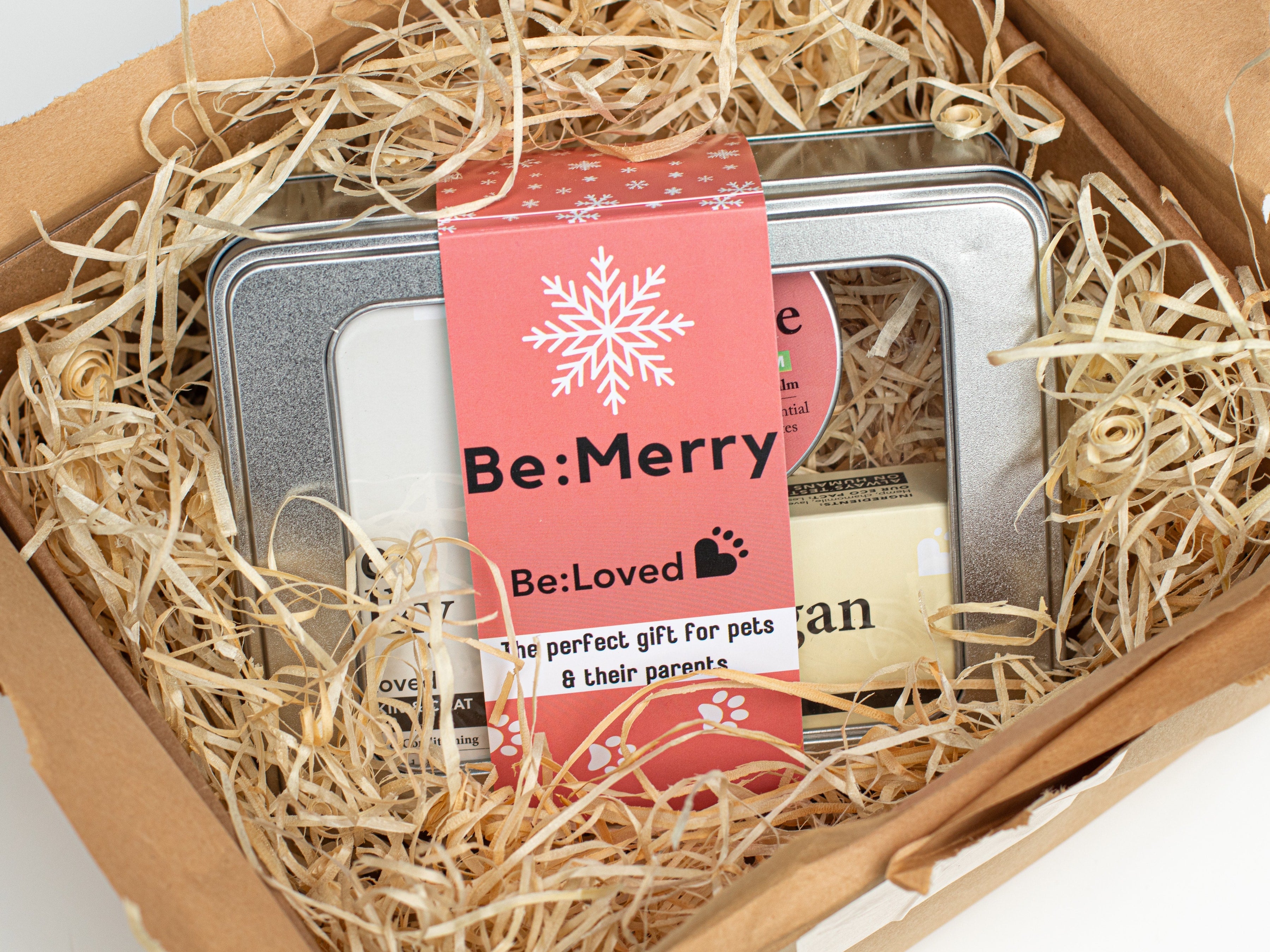 Be:Merry gift set being unboxed surrounded by straw and brown wrapping paper