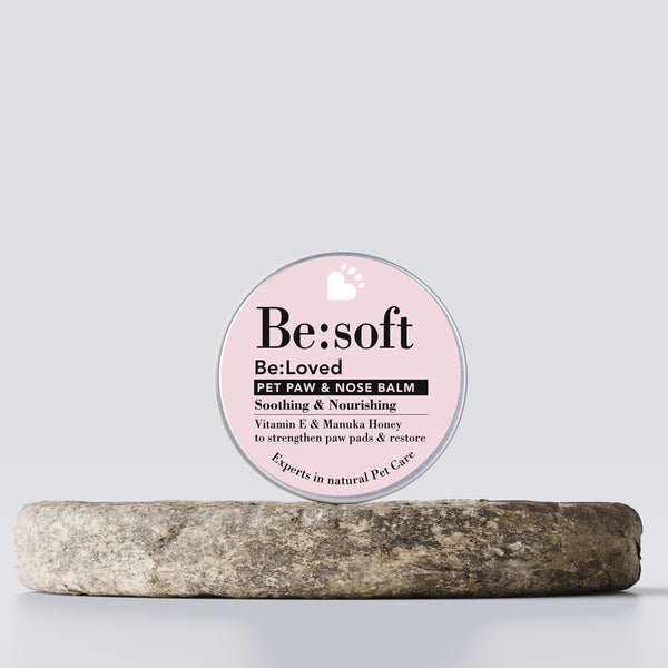 Be:soft pet paw and nose balm on a wooden tray.