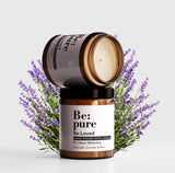 Be:pure candle product - one face on to see the packaging and the other above to see the view of the candle, both on a background of lavender.