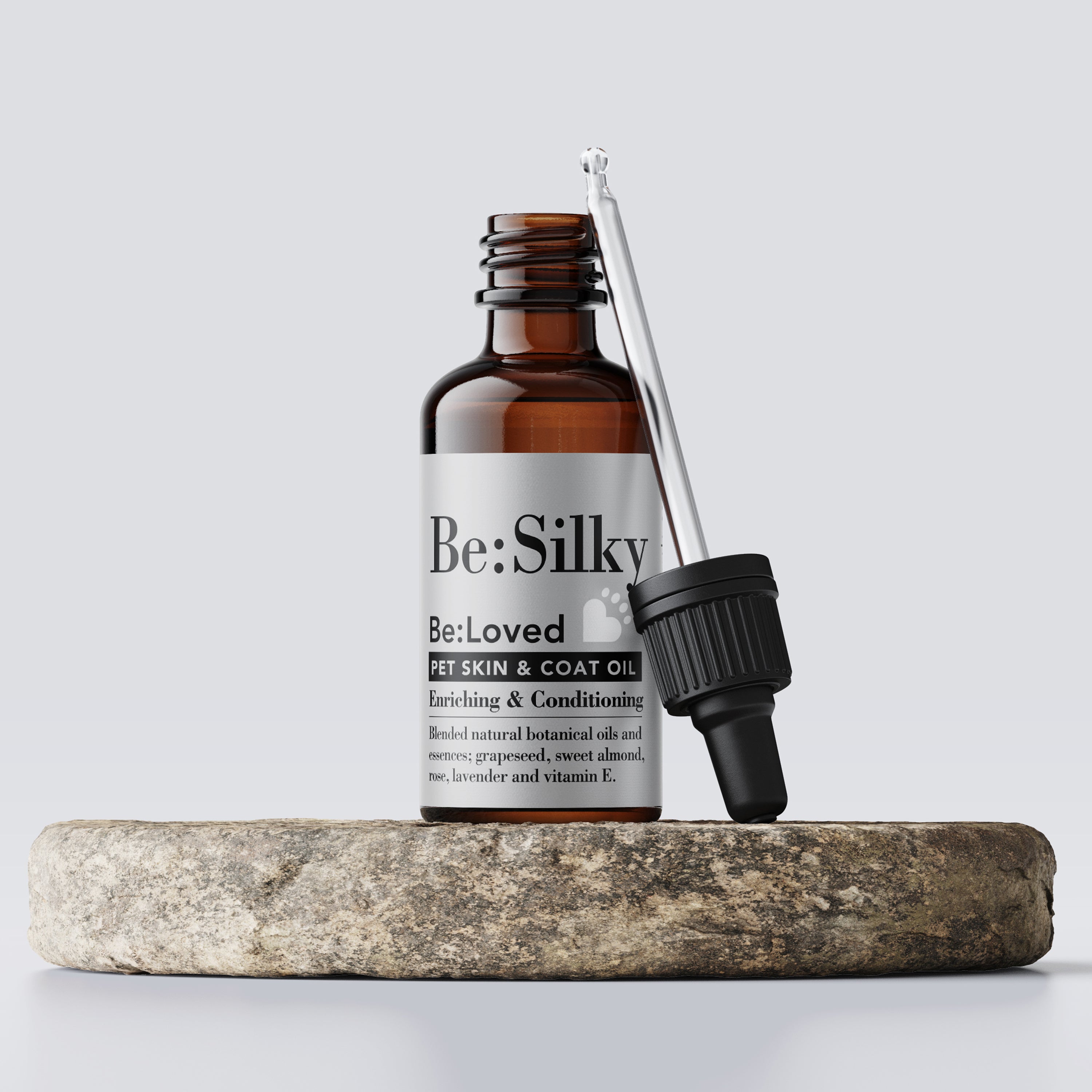 Be:silky pet skin and coat oil product in glass bottle packaging on a wooden tray.