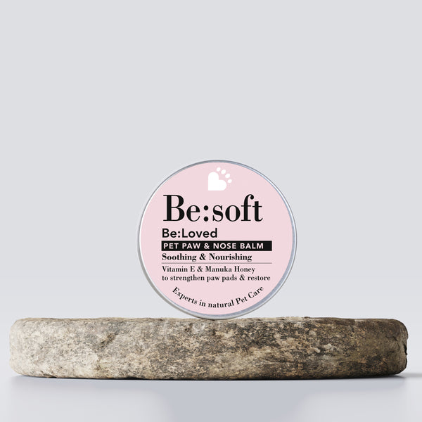 Be:soft pet paw and nose balm product on a wooden tray.